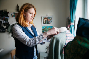 Scottish designer sewing clothes