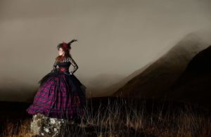 Model wearing tartan in the Highlands of Scotland